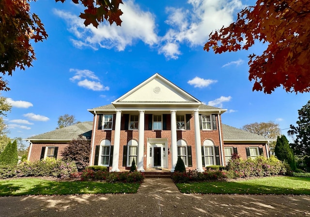 greek revival inspired property featuring brick siding