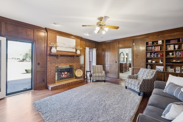 1608 Knox Dr, Brentwood, TN 37027 - living room with wooden walls, a brick fireplace, wood finished floors, and a ceiling fan