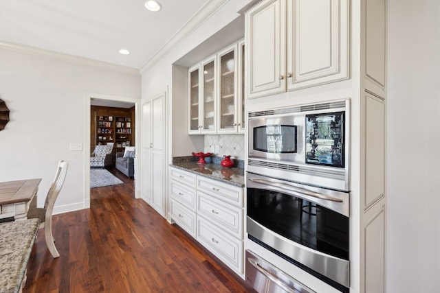 1608 Knox Dr, Brentwood, TN 37027 - kitchen with appliances with stainless steel finishes, stone countertops, a warming drawer, and dark wood-style flooring
