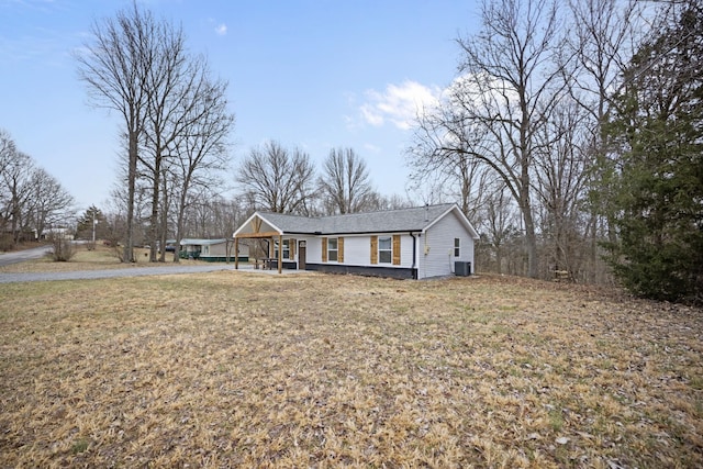 ranch-style home with a front lawn and a carport