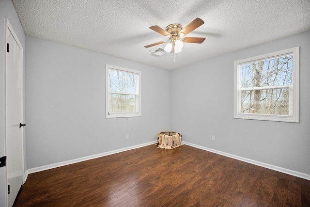 unfurnished bedroom with visible vents, a ceiling fan, a textured ceiling, wood finished floors, and baseboards