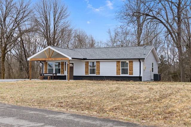 ranch-style house with a front yard, roof with shingles, and central AC