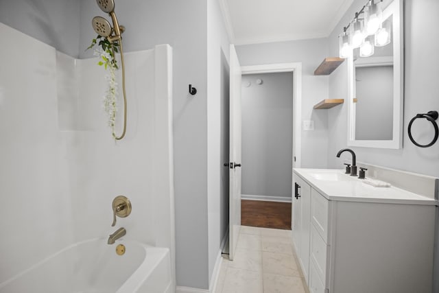 bathroom with tub / shower combination, crown molding, vanity, and baseboards