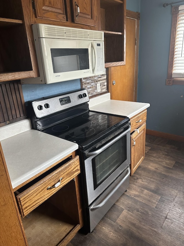26 Central Ave, Tullahoma, TN 37388 - kitchen featuring light countertops, white microwave, open shelves, and stainless steel range with electric cooktop