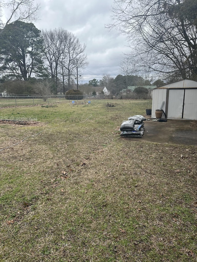 26 Central Ave, Tullahoma, TN 37388 - view of yard featuring a storage shed, fence, and an outbuilding