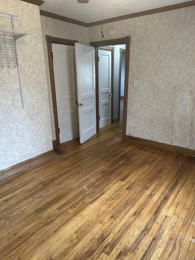 26 Central Ave, Tullahoma, TN 37388 - unfurnished bedroom featuring ornamental molding and wood finished floors