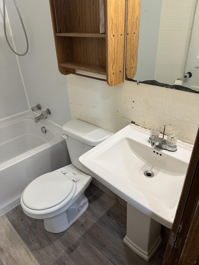 26 Central Ave, Tullahoma, TN 37388 - full bathroom with backsplash, toilet, and wood finished floors