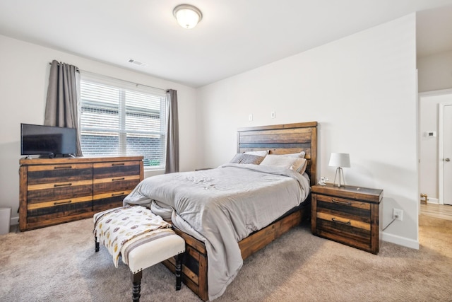 carpeted bedroom featuring visible vents and baseboards