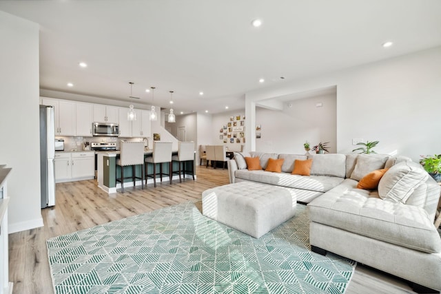 living room featuring light wood-style flooring and recessed lighting