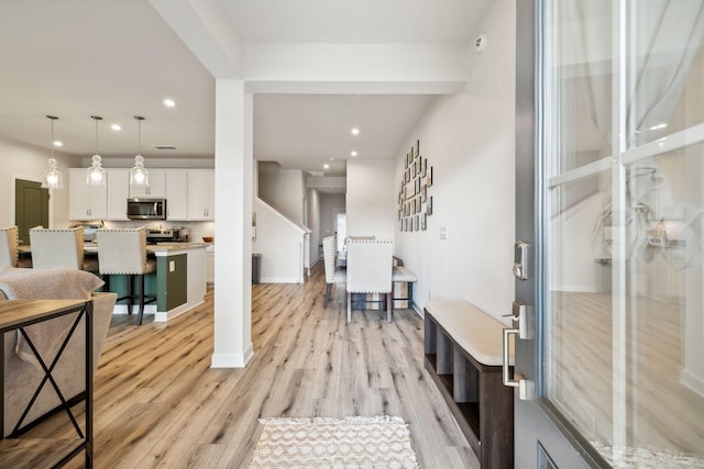 entrance foyer with light wood-style flooring, baseboards, and recessed lighting