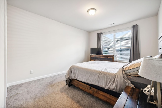 carpeted bedroom with visible vents and baseboards