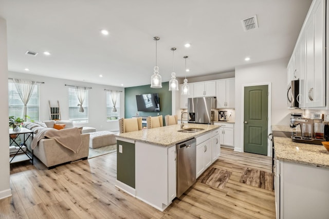 kitchen featuring stainless steel appliances, recessed lighting, visible vents, light wood-style floors, and white cabinets