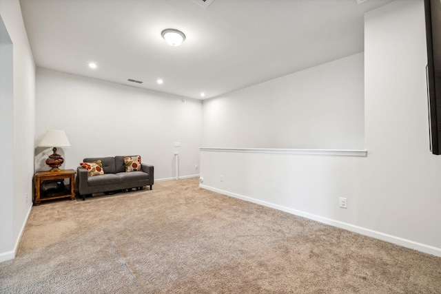 sitting room with baseboards, visible vents, and carpet flooring