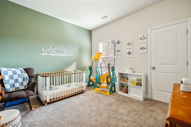 carpeted bedroom featuring a nursery area and visible vents