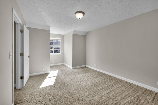 unfurnished bedroom featuring a textured ceiling, baseboards, and carpet flooring