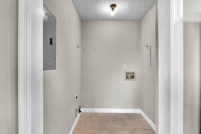 clothes washing area with light tile patterned floors, hookup for a washing machine, a textured ceiling, laundry area, and electric panel