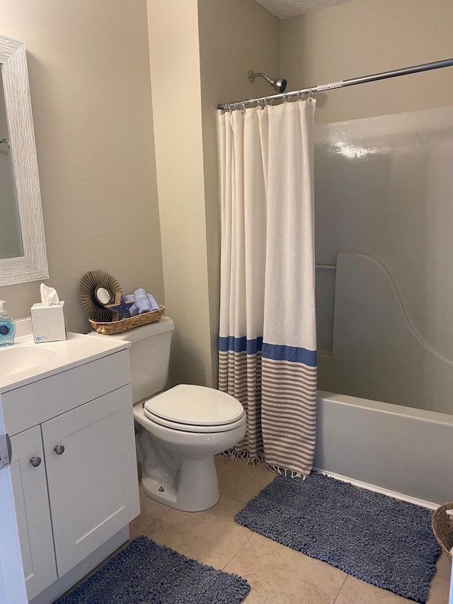 bathroom featuring shower / tub combo, vanity, toilet, and tile patterned floors