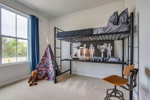 bedroom featuring carpet and baseboards