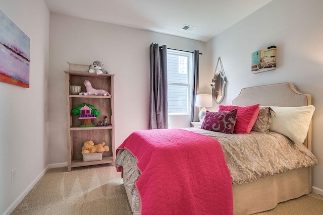 carpeted bedroom featuring visible vents and baseboards