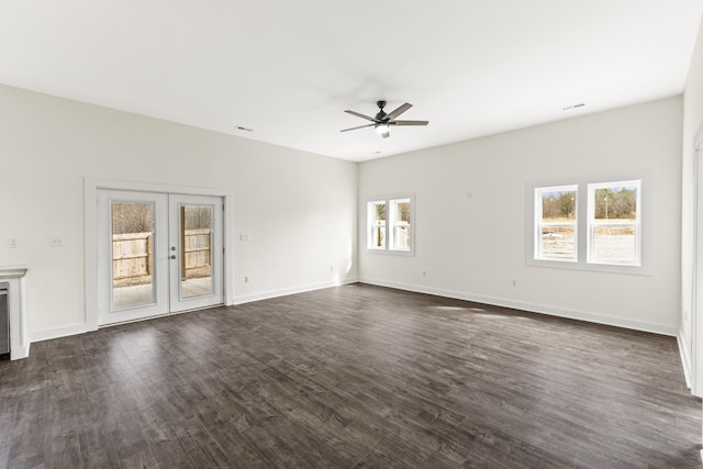 unfurnished living room with baseboards, dark wood-style flooring, and french doors