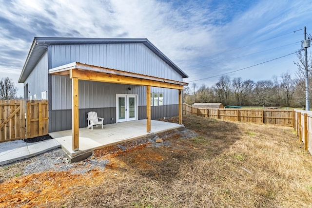 back of house featuring a fenced backyard, a patio, and french doors