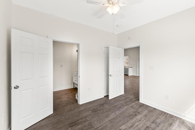 unfurnished bedroom with ceiling fan, dark wood-style flooring, and baseboards