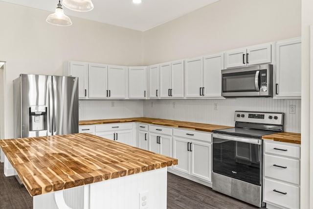 kitchen featuring white cabinets, butcher block counters, appliances with stainless steel finishes, and dark wood finished floors