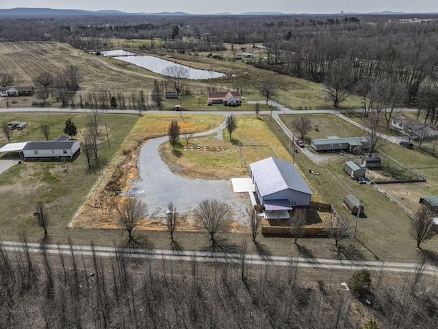 drone / aerial view featuring a water view and a rural view