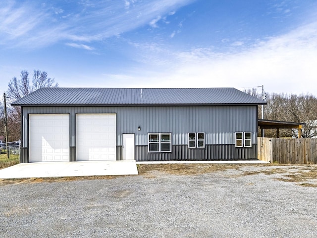 detached garage featuring fence