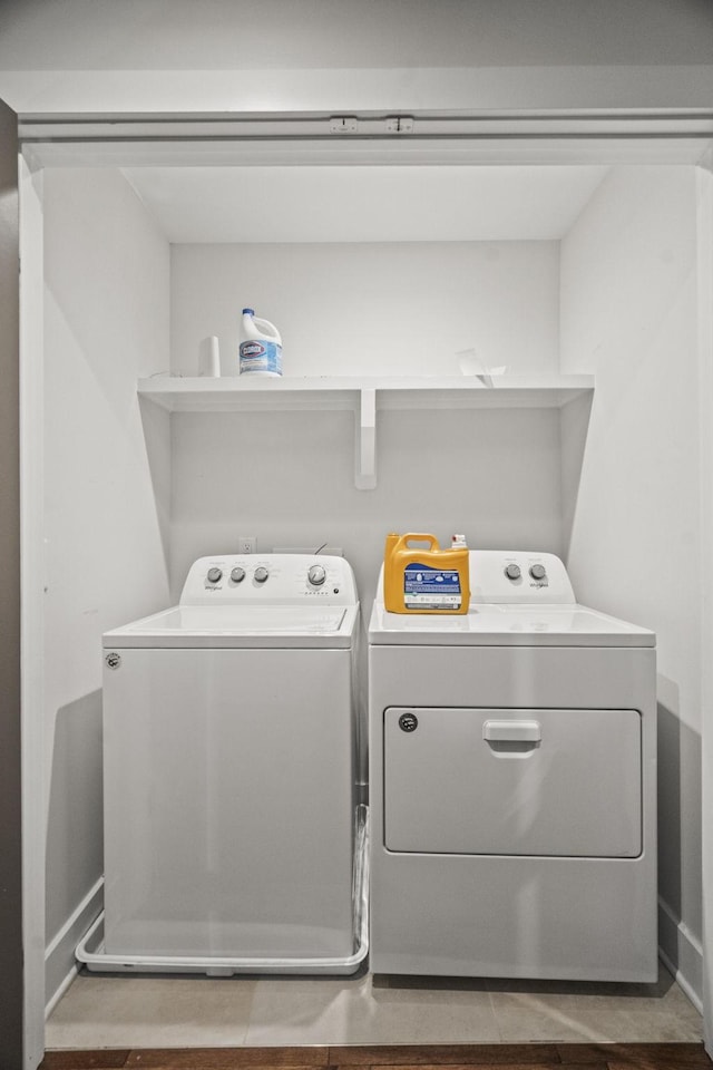 laundry area with washing machine and dryer and baseboards