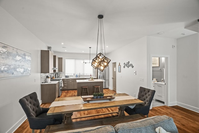 dining area featuring recessed lighting, baseboards, and wood finished floors