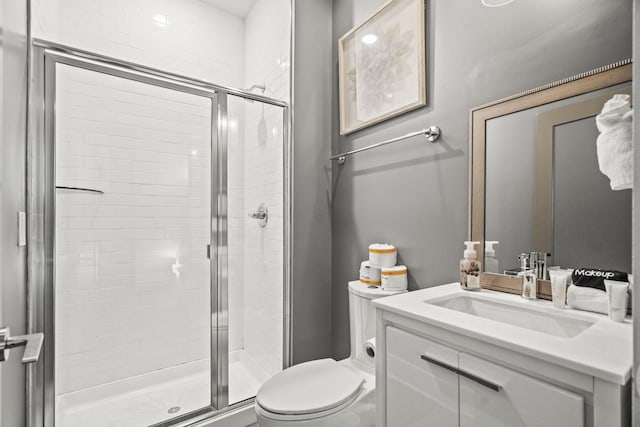 full bath featuring vanity, a shower stall, and toilet