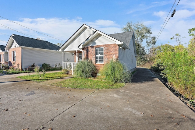 view of front of property with covered porch and brick siding