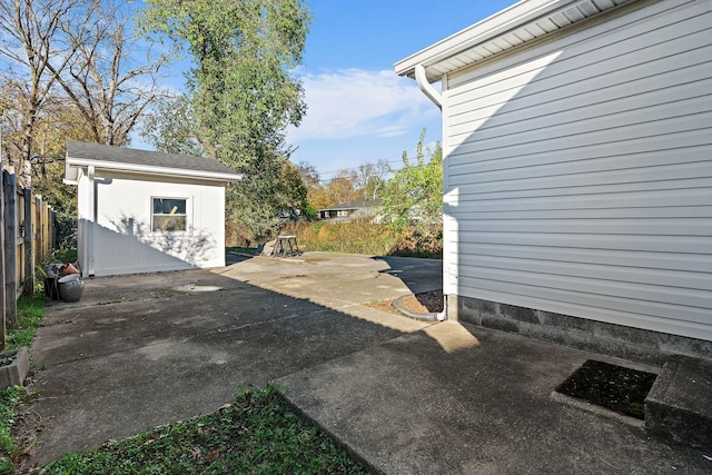 view of patio featuring a fenced backyard and an outdoor structure