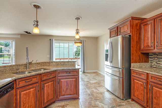 kitchen with appliances with stainless steel finishes, decorative backsplash, a sink, and pendant lighting