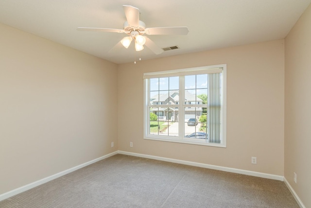 unfurnished room featuring a ceiling fan, baseboards, visible vents, and carpet flooring