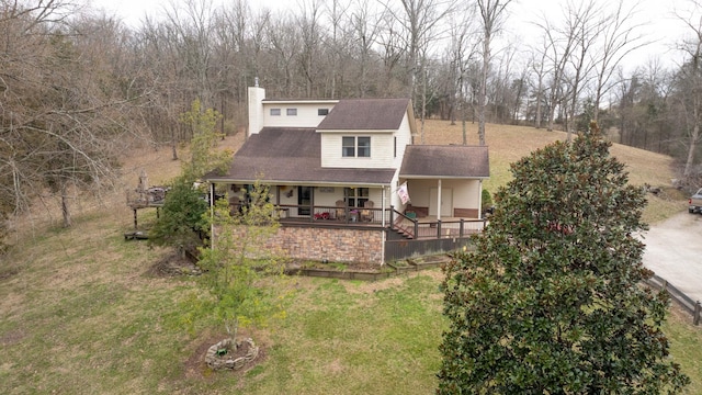 view of front of house featuring a chimney and a front yard