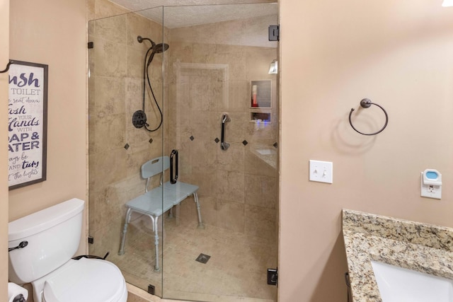 full bath with a stall shower, vanity, and toilet