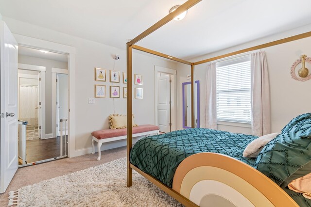 bedroom featuring carpet and baseboards