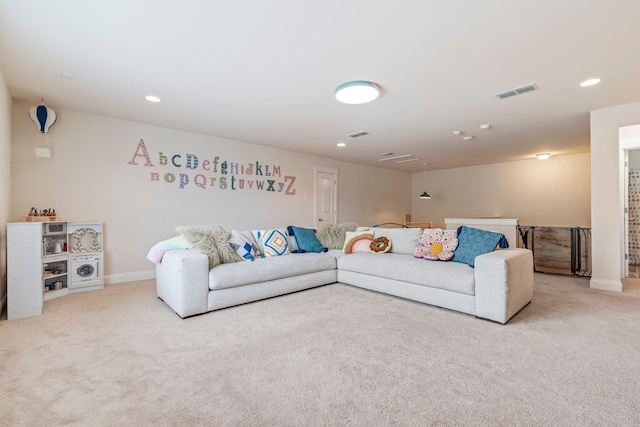 carpeted living area featuring baseboards, visible vents, and recessed lighting