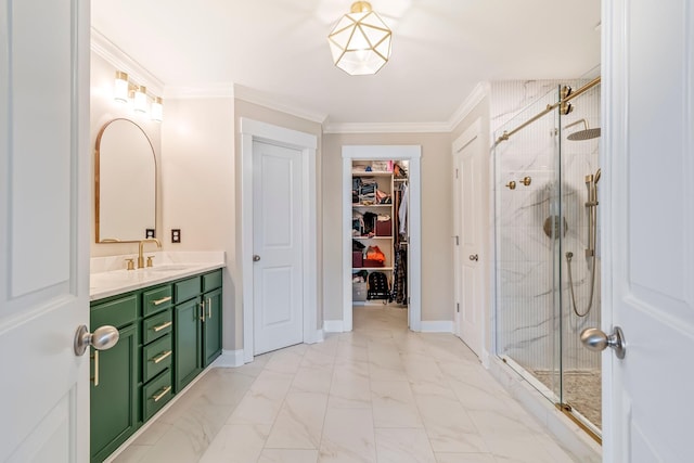 full bath featuring marble finish floor, a walk in closet, crown molding, vanity, and a shower stall