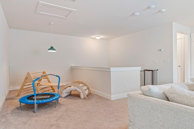 recreation room with attic access, carpet flooring, and baseboards