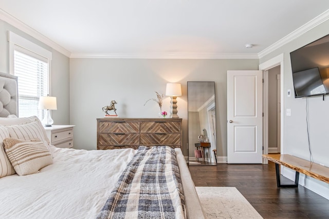 bedroom featuring dark wood-type flooring, ornamental molding, and baseboards