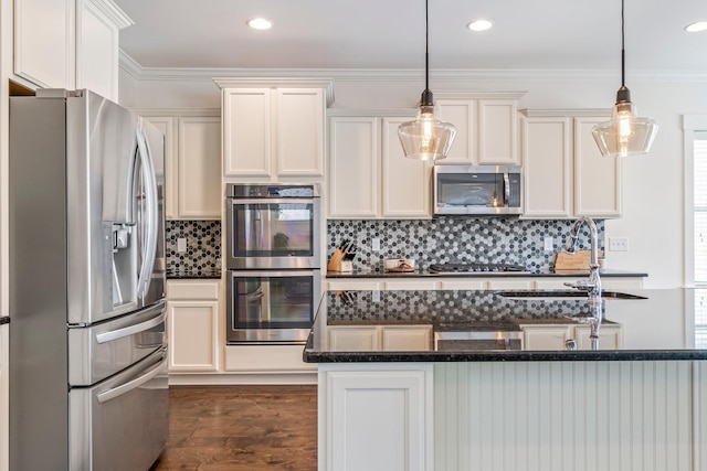 kitchen featuring decorative light fixtures, dark wood finished floors, stainless steel appliances, backsplash, and ornamental molding