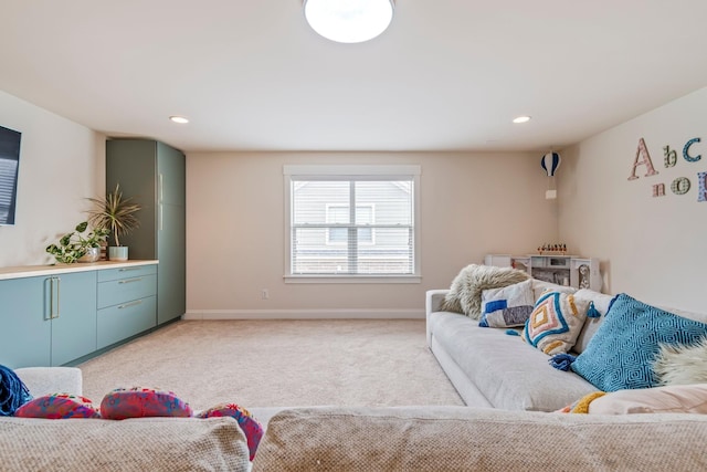 living area featuring light carpet, recessed lighting, and baseboards