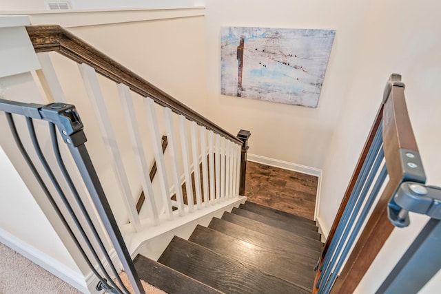 stairs featuring wood finished floors and baseboards