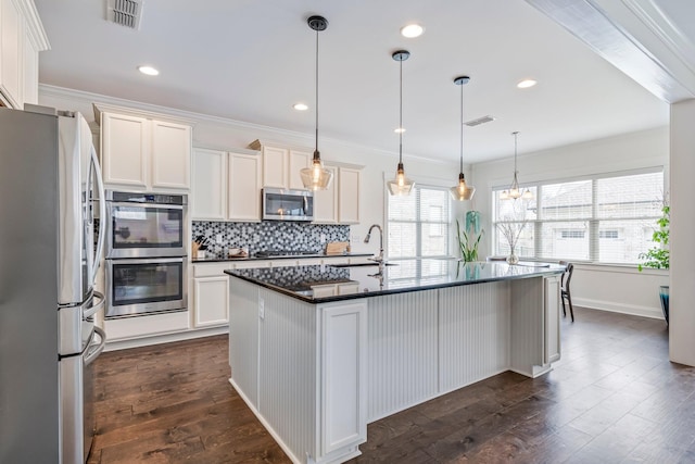 kitchen featuring tasteful backsplash, visible vents, dark countertops, dark wood-type flooring, and stainless steel appliances