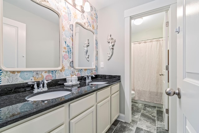 full bath with toilet, curtained shower, double vanity, and a sink