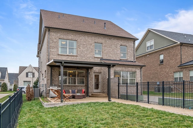 rear view of property with a fenced backyard, brick siding, an outdoor living space, a lawn, and a patio area