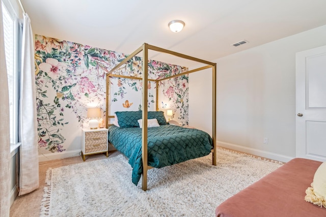 bedroom featuring carpet, visible vents, and baseboards